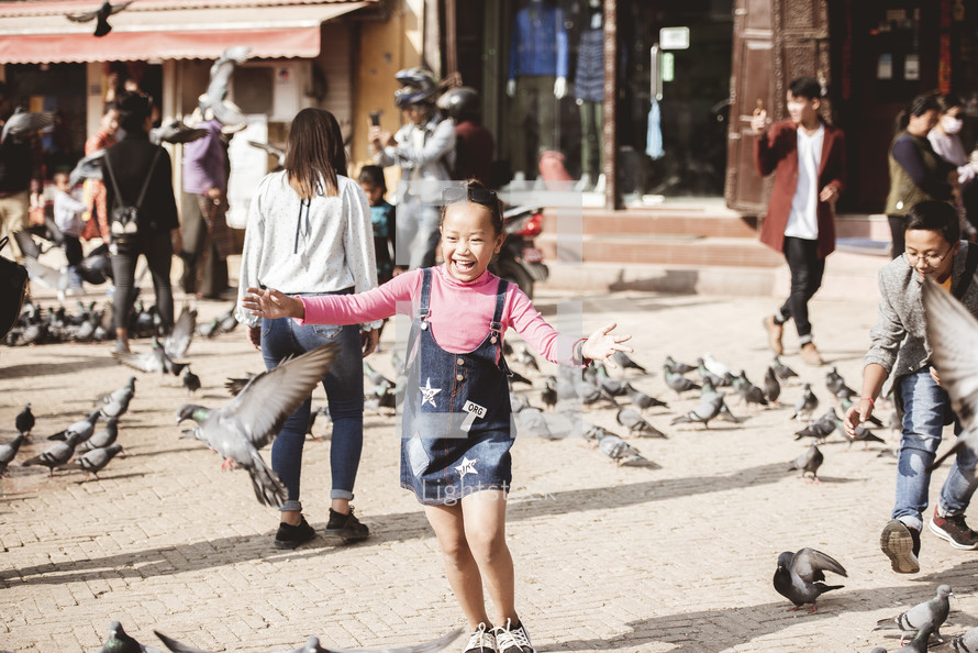 child chasing pigeons in Tibet