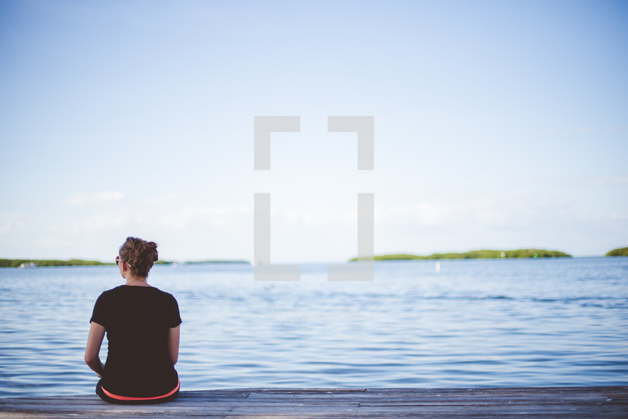 woman sitting on a dock 