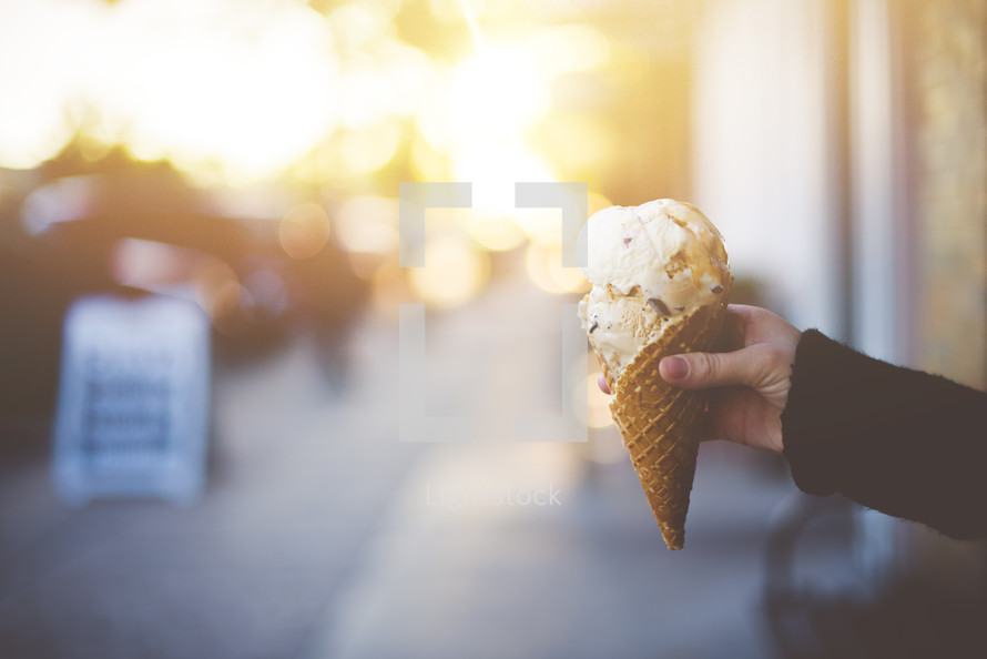 holding an ice cream cone 