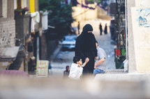 Muslim mother walking with her child through the streets of a city in Egypt 