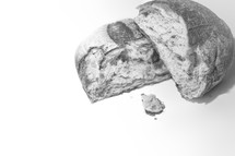 Broken loaf of bread on a white background 