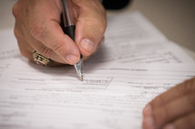 a man signing a document 