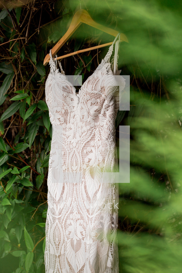 Wedding dress hung up in the forest