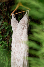 Wedding dress hung up in the forest