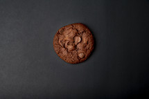 chocolate chocolate chip cookie on a black background 