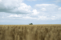 Combine harvester in a field, harvest time farming photo, rural countryside setting, agriculture