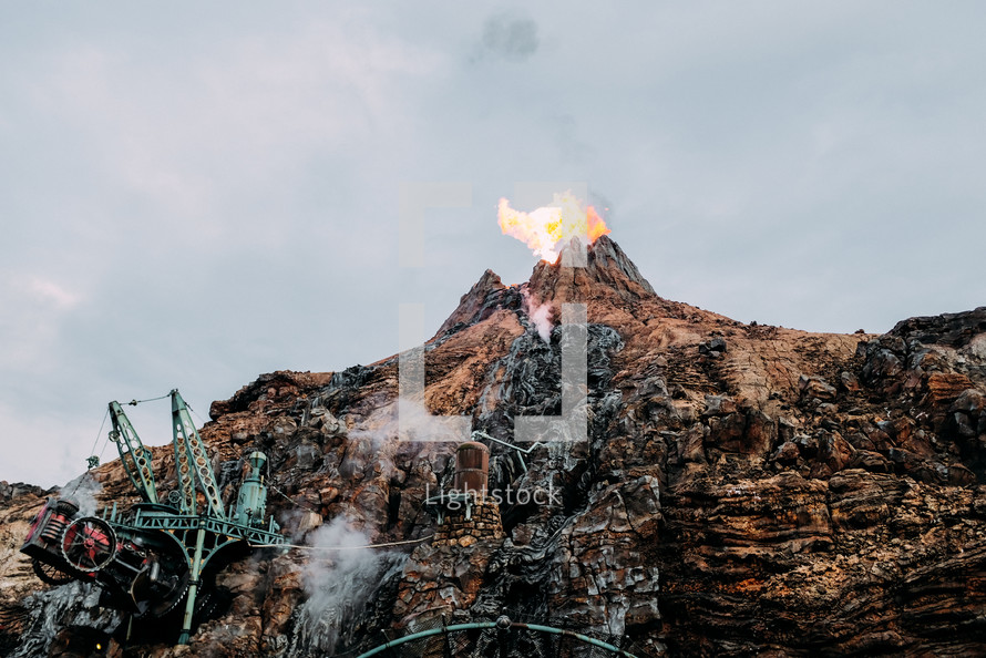 flame coming from a mountain peak 