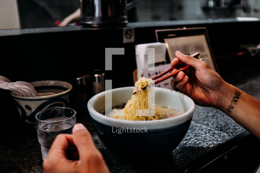 woman eating noodles in Japan 