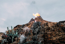 flame coming from a mountain peak 