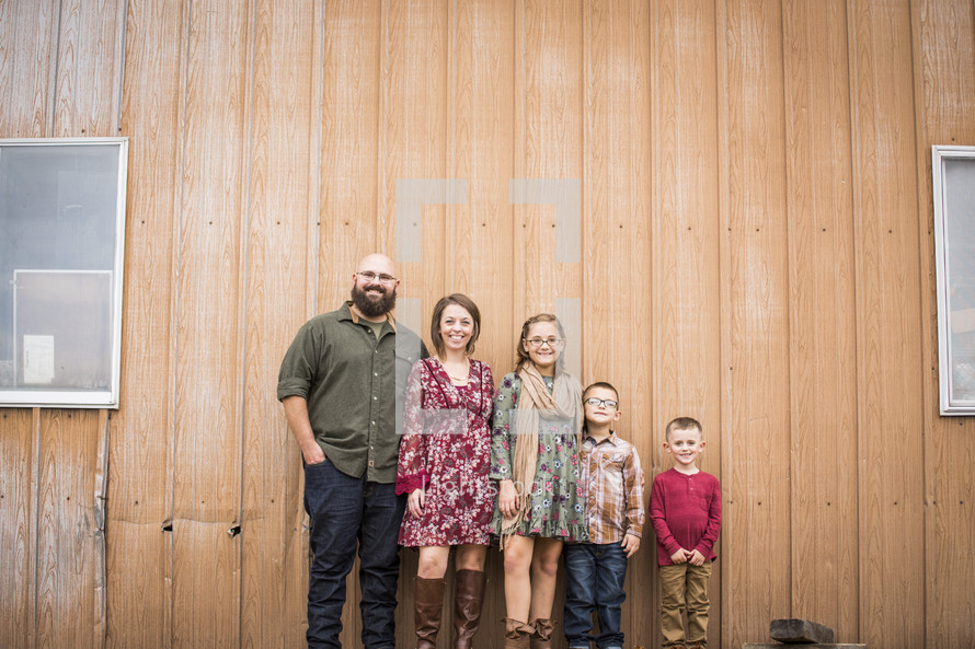 family portrait in front of a barn 