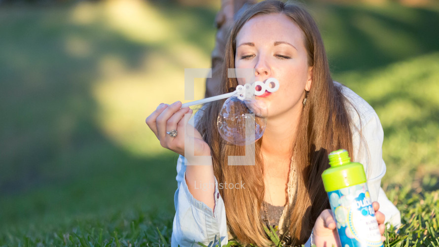 woman blowing bubbles 