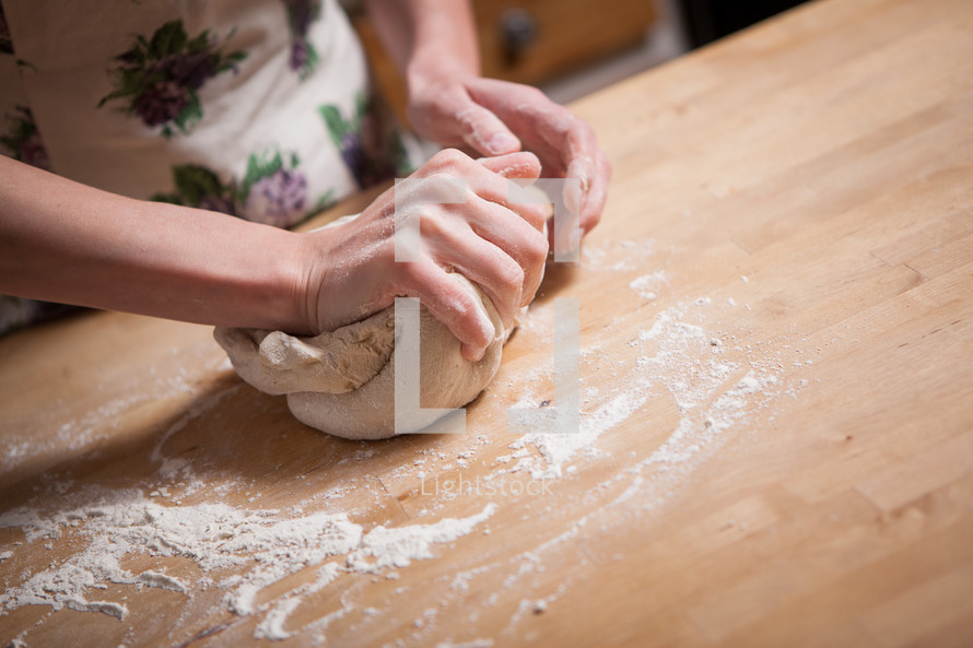 a woman kneading dough