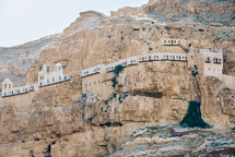 fortress built into a mountain cliff 