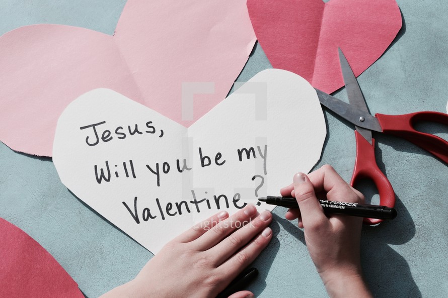 a little girl making Valentine's day card's for Jesus 