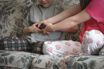 siblings fighting over a remote control 