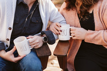 couple with his and hers coffee mugs 