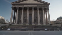 Paris, France - The majestic neoclassical facade of La Madeleine Church in Paris, with its grand Corinthian columns.