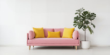 Modern minimalist interior with an elegant pink sofa adorned with yellow cushions and a potted monstera plant.