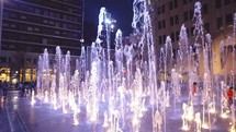 children playing in fountains at night in Fort Worth 