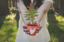 girl holding a flower pot 
