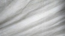 Linen cloth shroud backdrop with light and sun shining through it that is white and pure and without blemish or stain. 