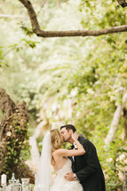 bride and groom kissing outdoors