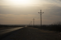 Electric wires along an empty rural highway
