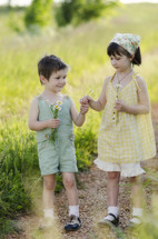 Brother and sister picking flowers