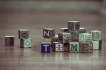 pile of wood blocks on a playroom floor and the word time 
