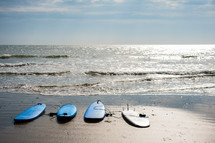 surfboards on a beach 