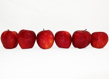 Row of red apples.
