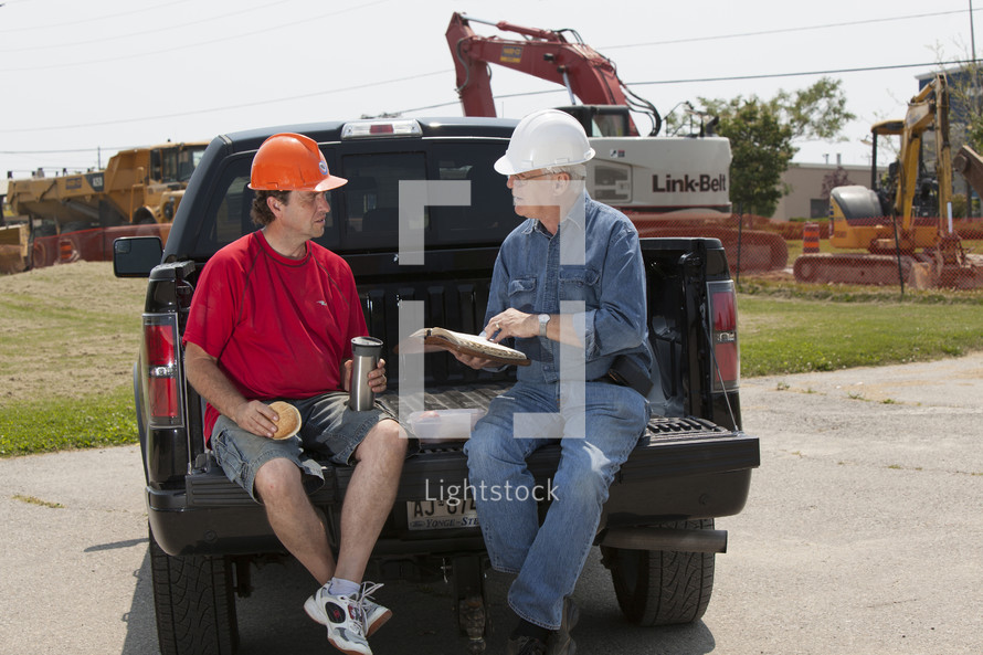 contractors planning in a truck bed 