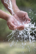 Water splashing in cupped hands.