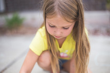 A young girl plays outside.
