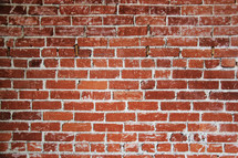 Red bricks laid in courses to form a brick wall