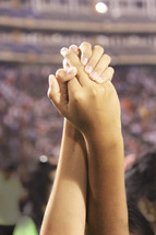 holding raised hands  during prayer for the Nation