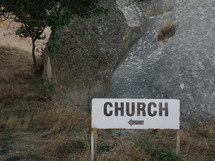 sign pointing the way to a church 