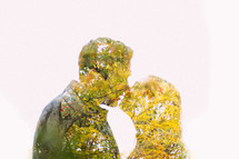 silhouette of fall leaves of a couple kissing 
