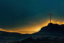Shining cross on Calvary hill, sunrise, sunset sky background. Copy space. 