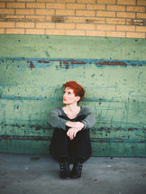 looking up, model, woman, sitting, sidewalk, redhead, outdoors, posing, short hair 