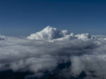 Thunderhead building in a sea of clouds.