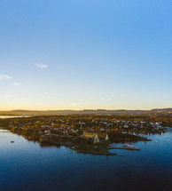 Aerial view over a coastal community at sunset 