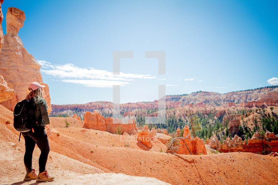 a woman hiking a red rock canyon 