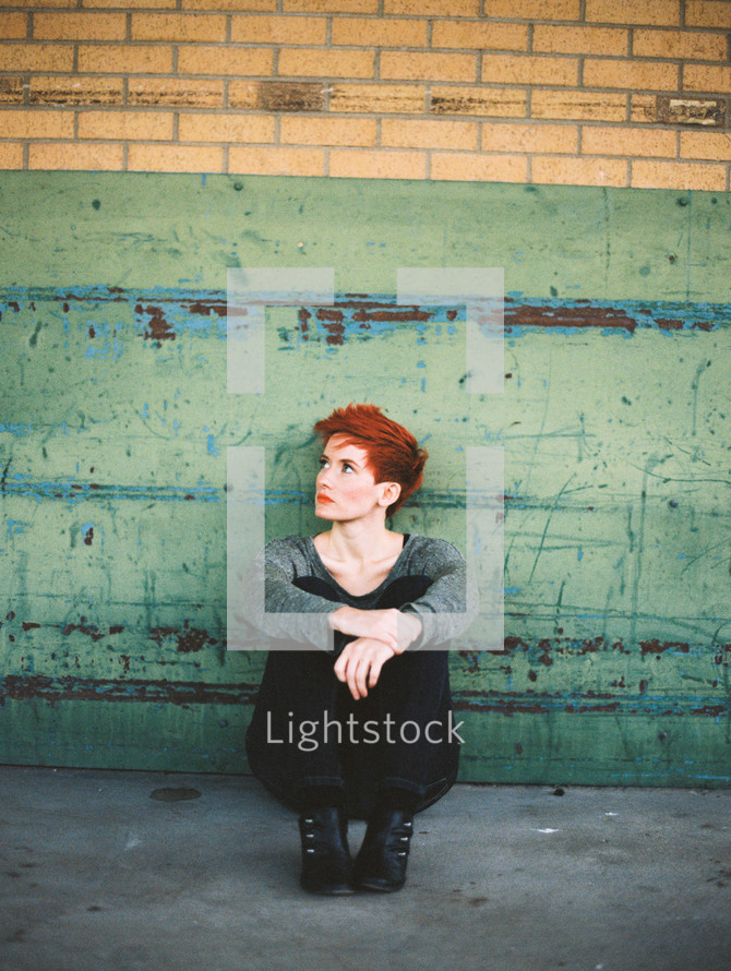 looking up, model, woman, sitting, sidewalk, redhead, outdoors, posing, short hair 