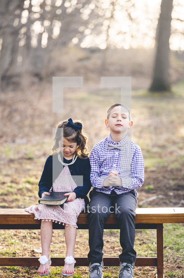 brother and sister together holding a Bible on Sunday morning 
