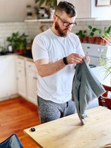 a man folding laundry 
