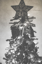 A Christmas tree decorated with ornaments and a star