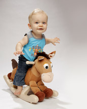 toddler boy on a rocking horse 