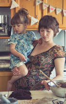 mother and daughter together in a kitchen 