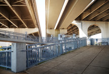 View of underneath a highway bridge and pedestrian area